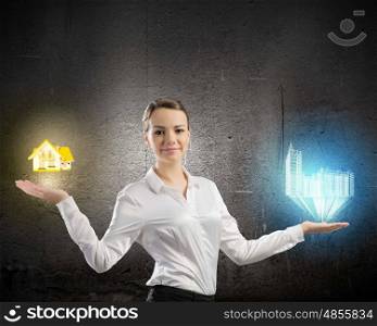 Balance concept. Image of businesswoman holding items on palm. Urban or country