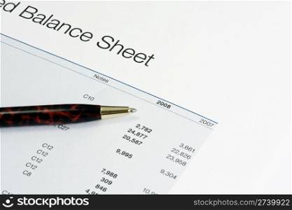 Balance sheet and a pen closeup