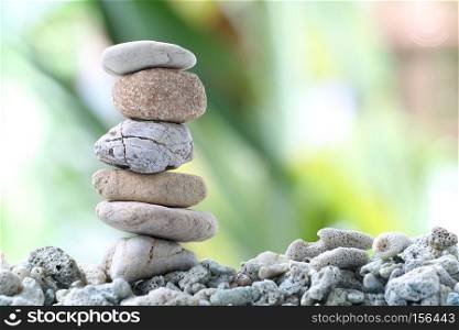 Balance stone on pile rock with garden background for concept of Zen and spa.