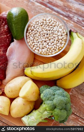 balanced diet, cooking, culinary and food concept - close up of different food items on wooden table