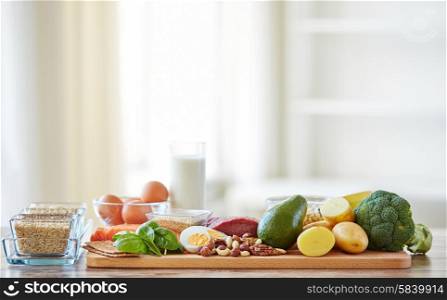 balanced diet, cooking, culinary and food concept - close up of vegetables, fruits and meat on wooden table