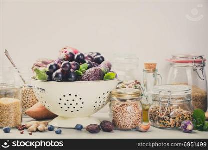 Balanced diet, cooking, vegetarian, raw and clean eating concept - close up of fresh organic fruits and vegetables, grains, legumes and nuts on concrete background with space for text. Healthy food concept