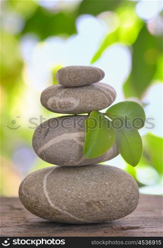 Balanced pebbles isolated on wooden table