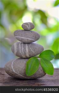 Balanced pebbles isolated on wooden table