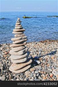 Balanced stones on the seashore summertime and blue sky background