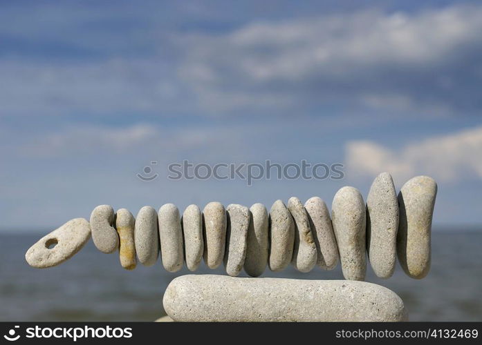 Balancing rocks in a row on the beach