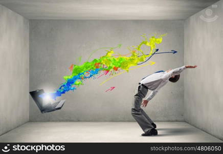 Balancing young man evading from explosion of ideas. Businessman evades splash ideas