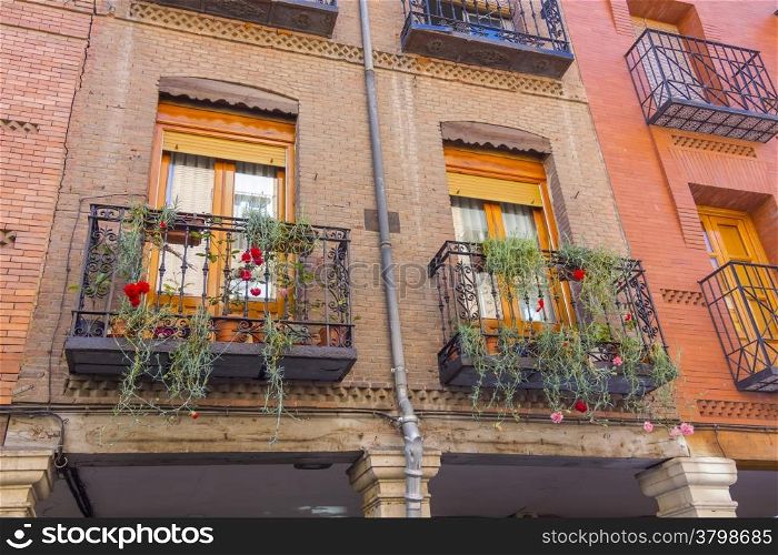 balconies with flowers in an old brick house