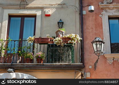 Balcony decorated with typical sicilian vases in Taormina, Italy
