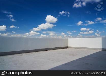 Balcony with blue sky and white clouds .