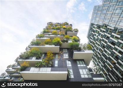 Balconys covered with trees and green plants on a tall building