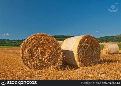 bale of straw with a blue sky. grain harvest