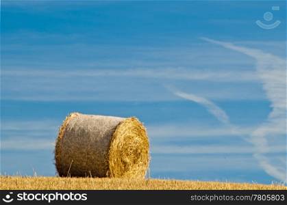 bale of straw with a blue sky. grain harvest