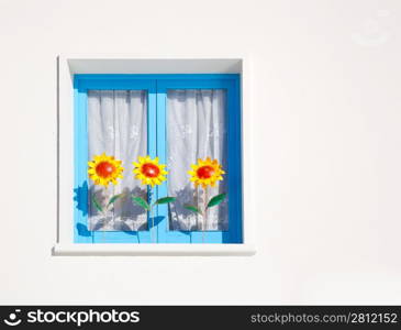 Balearic blue window with three sunflowers Mediterranean architecture detail