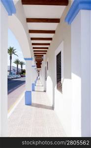 Balearic Formentera island La Savina narrow arcade in white houses