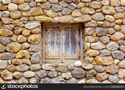 Balearic islands masonry stone wall with grunge wood window