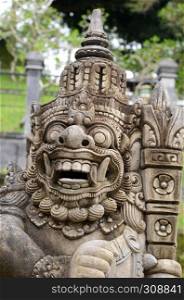 Bali sculpture as a guard in front of temple