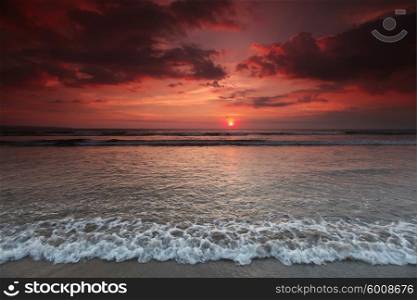 Bali sunset. Beautiful sea beach under coudy sunset sky on Bali