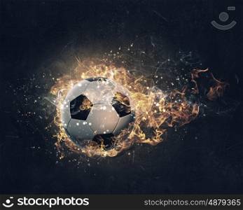 Ball burning in fire. Soccer ball in fire flames on dark background