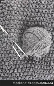 Ball of wool for knitting and needles on the knitted items