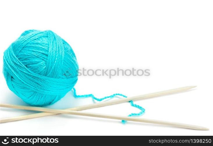 Ball of woolen thread and knitting needles isolated on white background. The concept is hobbies and handicrafts. Free space for text.