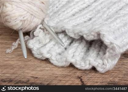 ball of yarn and mittens on a background pattern