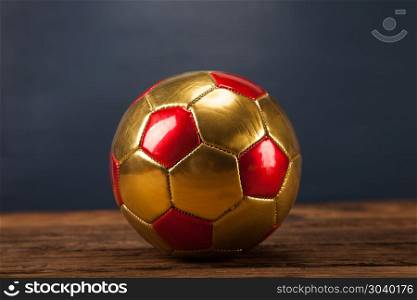 Ball on wooden table and blue background