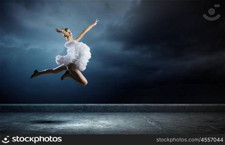 Ballerina girl. Young girl dancer jumping high in sky