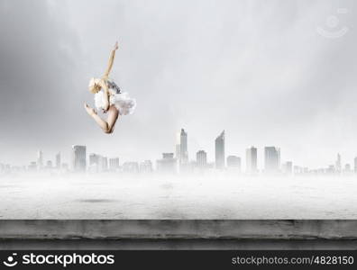 Ballerina girl. Young girl dancer jumping high in sky