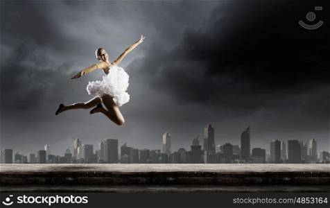 Ballerina girl. Young girl dancer jumping high in sky