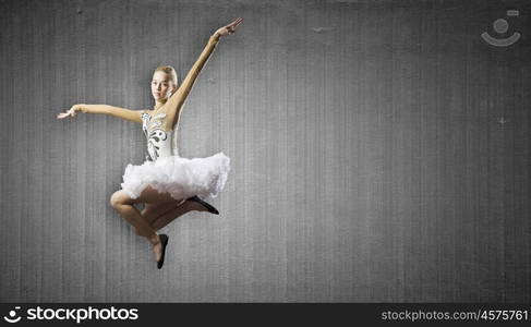 Ballerina girl. Young pretty ballerina girl making jump in dance