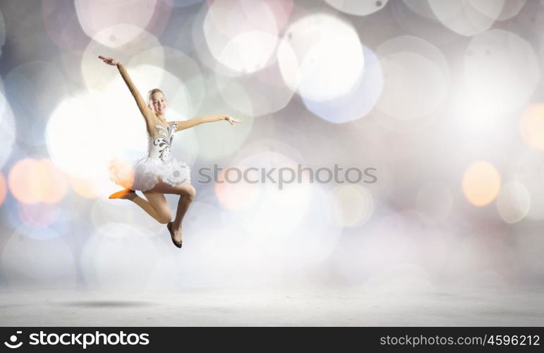 Ballerina girl. Young pretty ballerina girl making jump in dance