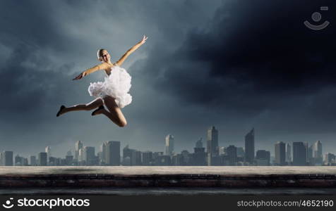 Ballerina girl. Young pretty ballerina girl making jump in dance