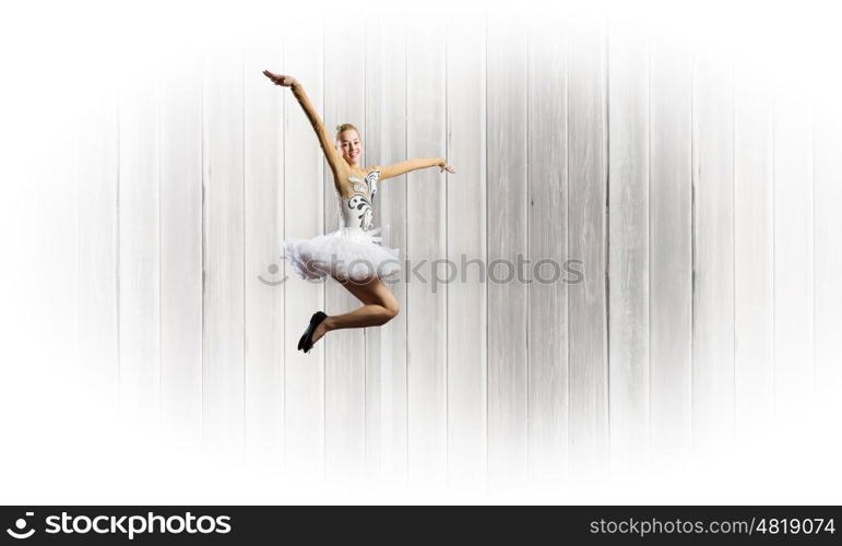 Ballerina girl. Young pretty ballerina girl making jump in dance