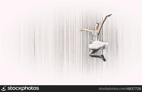 Ballerina girl. Young pretty ballerina girl making jump in dance