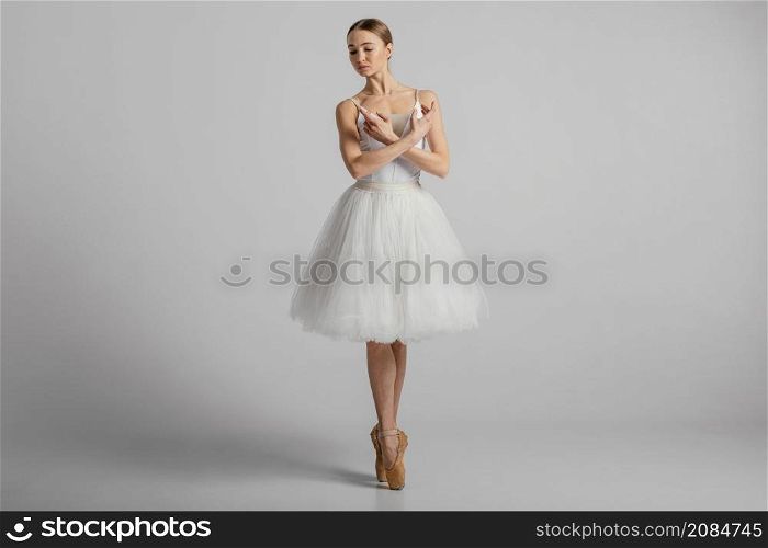 ballerina posing with pointe shoes full shot