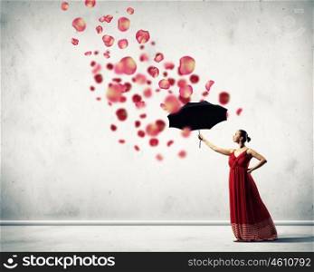 Ballet dancer in flying satin dress with umbrella. ballet dancer in flying satin dress with umbrella and flowers