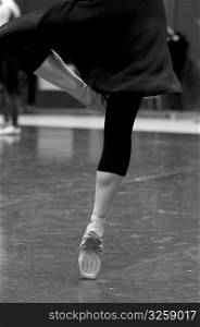 Ballet dancer practicing dances moves in studio.