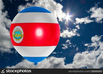 balloon in colors of costarica flag flying on blue sky