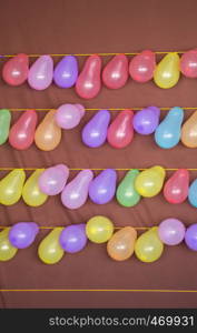 Balloon shooting game with balloons tied on a string