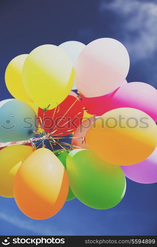 balloons and celebration concept - lots of colorful balloons in the sky