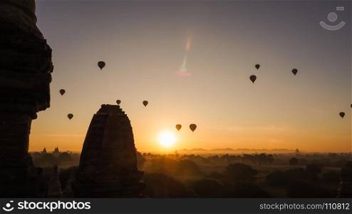 Balloons fly over the Buddhist temples at sunrise in Bagan, Myanmar. All temples in Bagan are considered sacred by the Burmese.