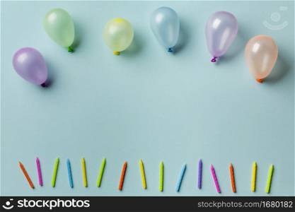balloons row colorful candles against blue background