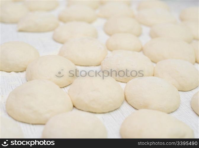 balls of raw pastry which will be buns, shallow DOF