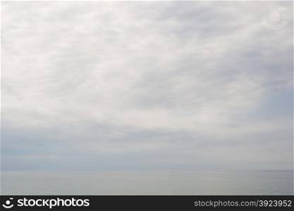 Baltic sea clouds, seascape and landscape in a gray tone with sail boat