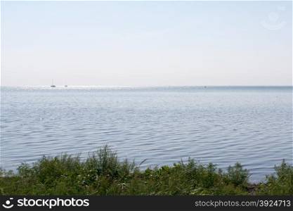 Baltic sea landscape. Baltic sea seascape and landscape in a gray tone with sail boats