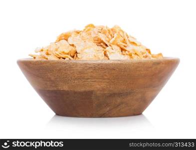 Bamboo wood bowl with natural organic granola cereal corn flakes on white.