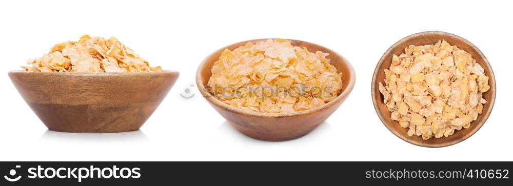 Bamboo wood bowl with natural organic granola cereal corn flakes on white.Top view
