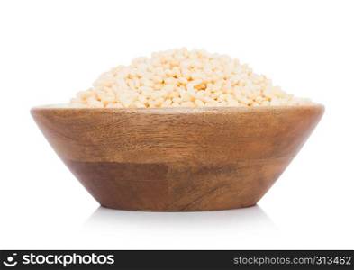 Bamboo wood bowl with natural organic granola cereal rice flakes on white.