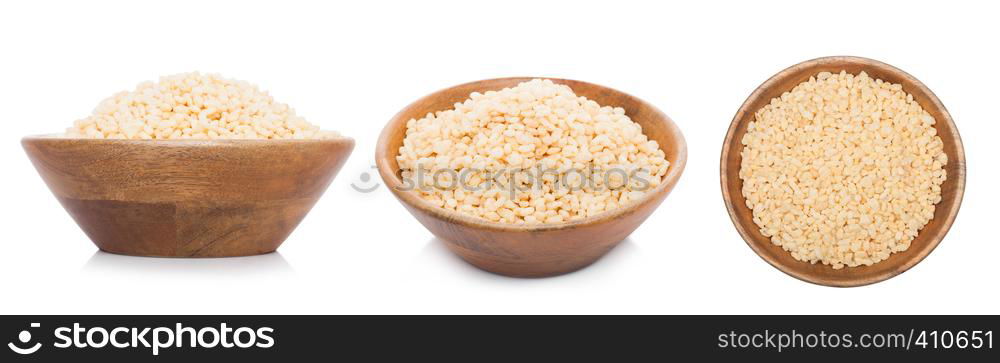 Bamboo wood bowl with natural organic granola cereal rice flakes on white.Top view